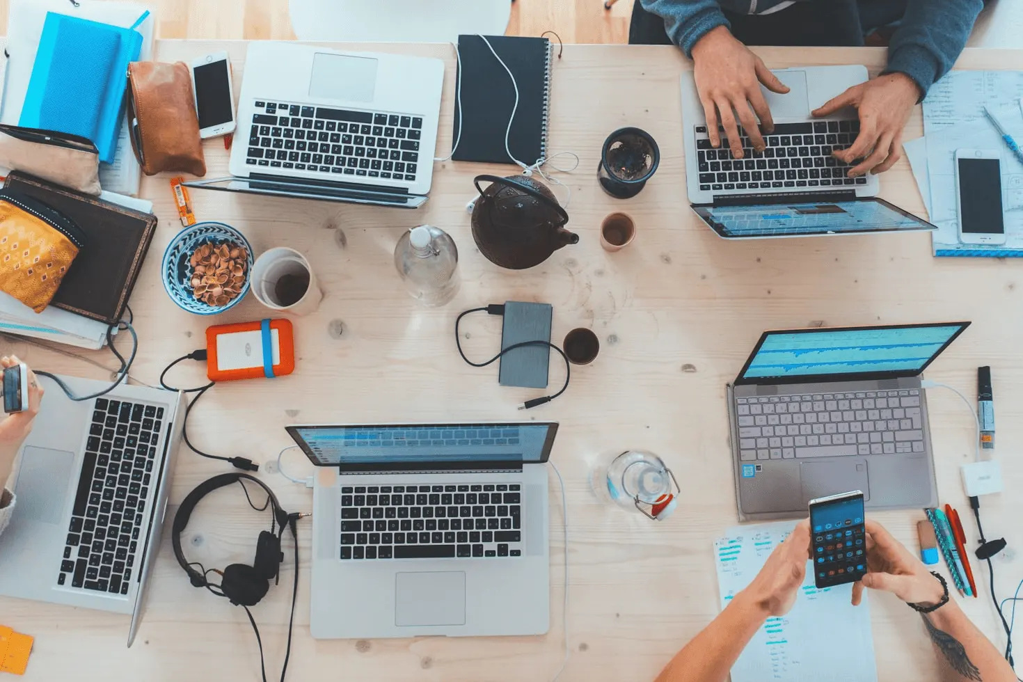 people with labtops working on a desk